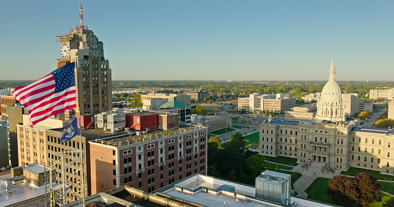 Aerial shot of downtown buildings in Lansing, Michigan on a sunny Fall morning, including the state capitol building and Boji Tower. \n\nAuthorization was obtained from the FAA for this operation in restricted airspace.
