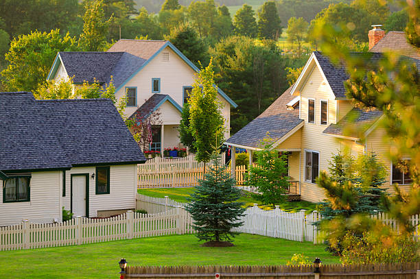 istock Three rural homes with white picket fences. 178064996