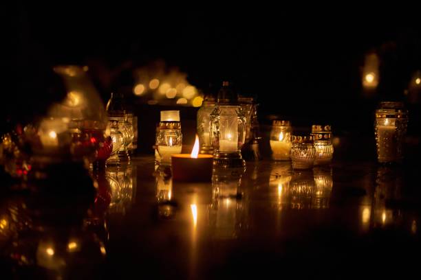 istock lit candles sitting on a table in the dark at night 1780655115