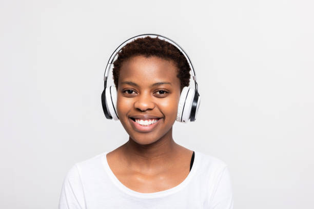 Smiley cheerful delighted african american woman wearing headphones headset earphones