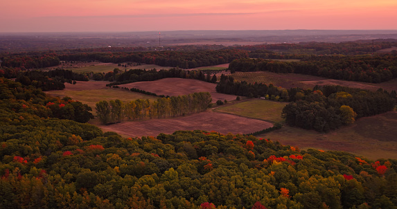 Aerial still of farmland near Shelby, a village in Oceana County in Michigan, at dawn in Fall.