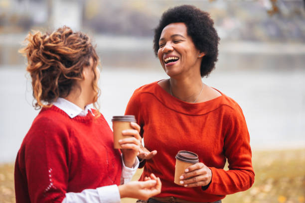 istock Two happy female friend talking enjoying autumn outdoors , drinks coffee. 1780666174