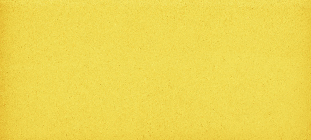 Bright yellow colored grunge textured effect - recycled paper