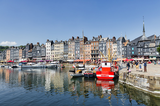 Honfleur, France - June 03, 2023: port of Honfleur with unidentified people in Calvados department, Normandy. Honfleur is known for its old port, characterized by its slate-covered houses