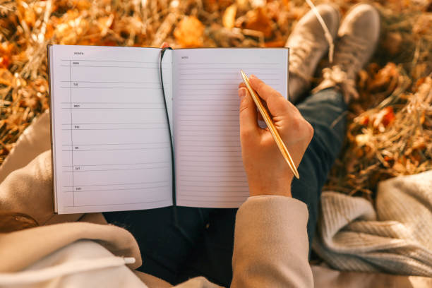 istock Girl with paper planner outdoors, autumn concept 1780693563