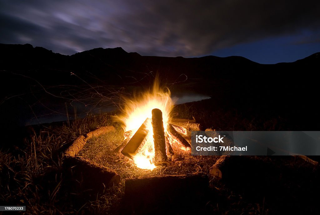 Camp fire beside lake and mountains. Camp fire beside lake and mountains. New Zealand Arrangement Stock Photo