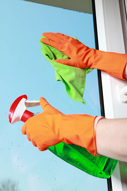 istock Gloved hand cleaning window rag and spray 178070378