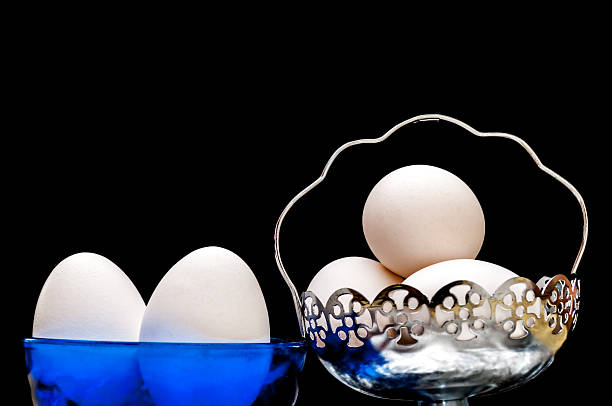 istock White eggs in glass bowl, basket, front lit, isolated 178071092