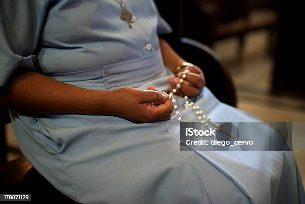 A Catholic Woman Holding Beads In Church Stock Photo - Download Image Now - Catholicism, Nun, Praying