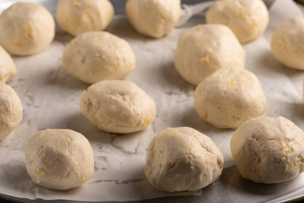 istock Cheese bread, pan with raw cheese breads ready to go in the oven, on rustic wood, selective focus. 1780721315