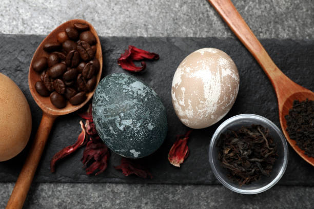 istock Naturally painted Easter eggs on grey table, top view. Hibiscus, tea and coffee beans used for coloring 1780740834