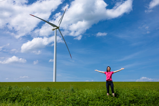 Woman standing near wind turbine