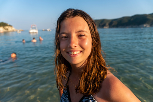 portrait of a teenage girl in a swimsuit at the sea