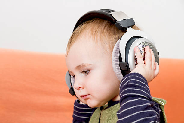 istock young child on couch with headphone 178075404