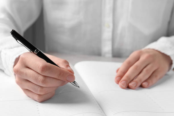 istock Woman with pen and notepad at light table, closeup 1780754899