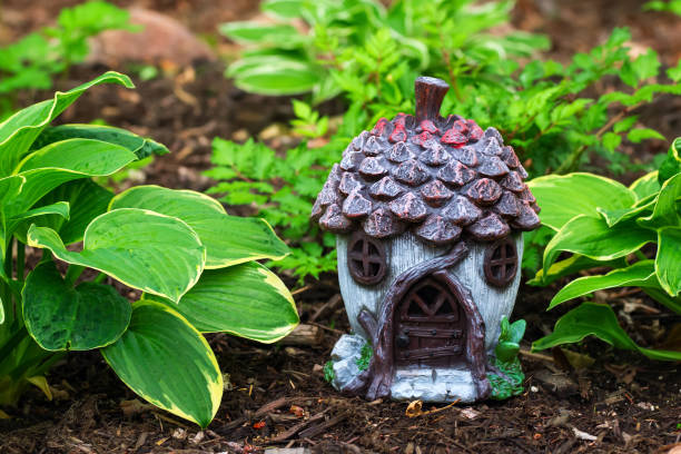 istock Little gnome cottage among hostas in a shade garden. 1780758761