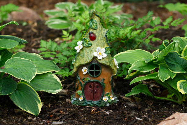 istock Little gnome cottage among hostas in a shade garden. 1780759901