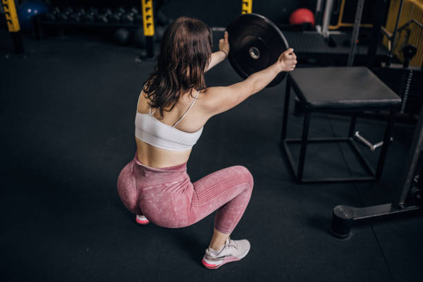 istock Young woman training with weight 1780759928
