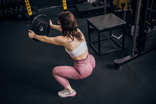 istock Young woman training with weight 1780760439