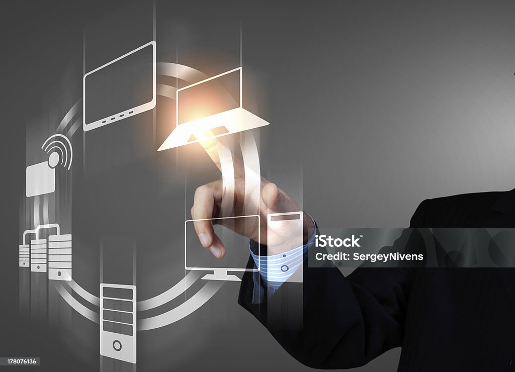 Hand tapping on a touch screen with electronic symbols Business person pushing symbols on a touch screen interface Backgrounds Stock Photo