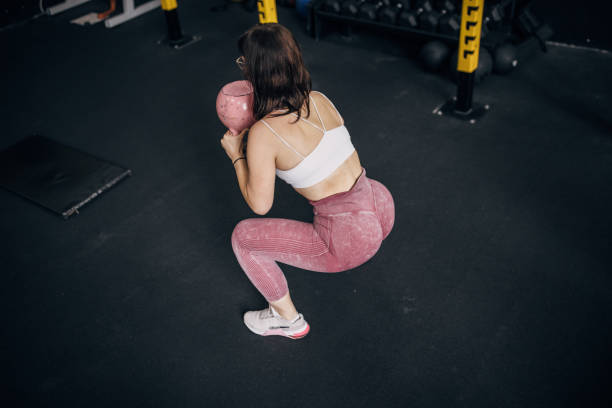 istock Young woman training with kettlebell 1780764309