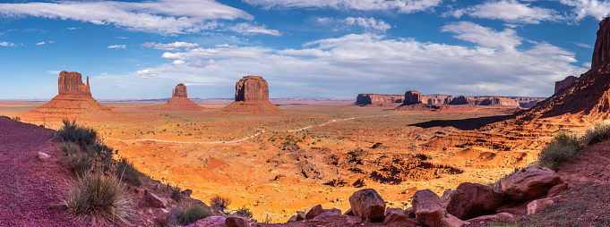 Monument Valley, on the Arizona - Utah border, gives us some of the most iconic and enduring images of the American Southwest.  The harsh empty desert is punctuated by many colorful sandstone rock formations.  It can be a photographer's dream to capture the ever-changing play of light on the buttes and mesas.  Even to the first-time visitor, Monument Valley will probably seem very familiar.  This rugged landscape has achieved fame in the movies, advertising and brochures.  It has been filmed and photographed countless times over the years.  If a movie producer was looking for a landscape that epitomizes the Old West, a better location could not be found.  This picture of the rock formations in the evening light was photographed from the Lee Cly Trail near the Monument Valley Visitor Center north of Kayenta, Arizona, USA.