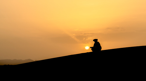 Silhouette of unidentified Berber man in Sahara Desert, Morocco
