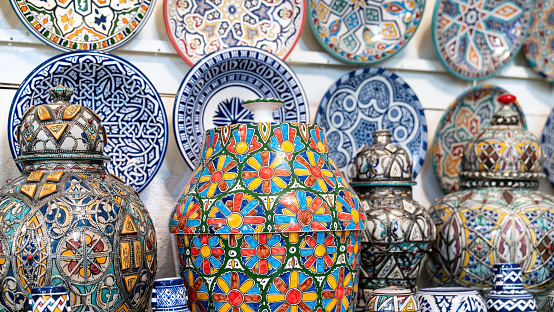 Moroccan pottery with colorful ceramics and pottery displayed outside shops in the souks, or traditional markets.