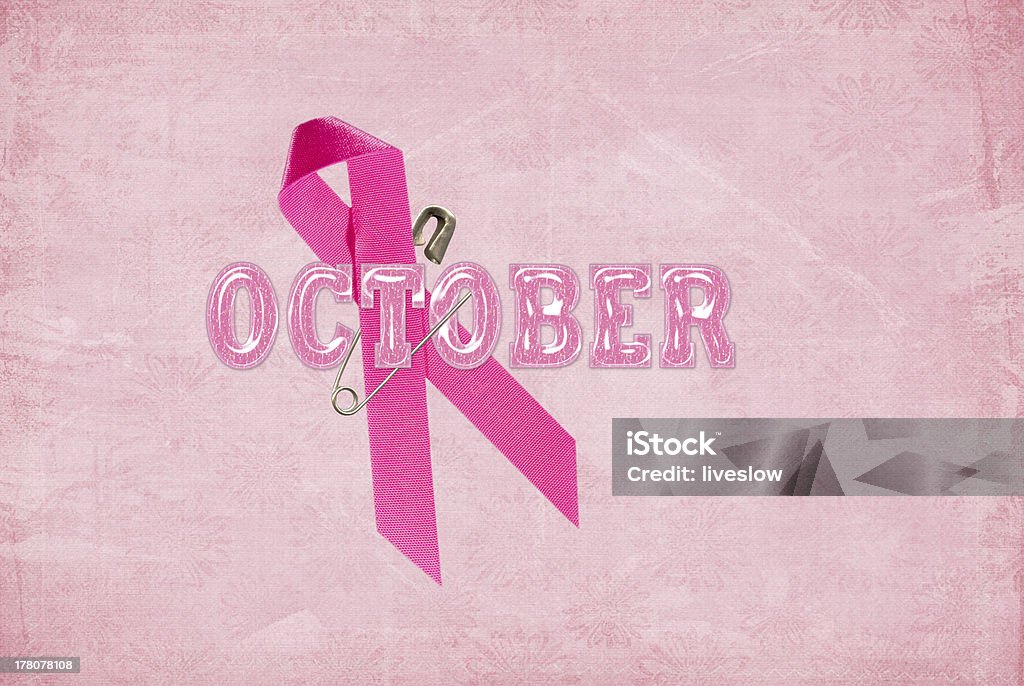 October Breast Cancer Awareness Ribbon Pink ribbon on with safety pin on textured background. Breast Cancer Awareness Stock Photo