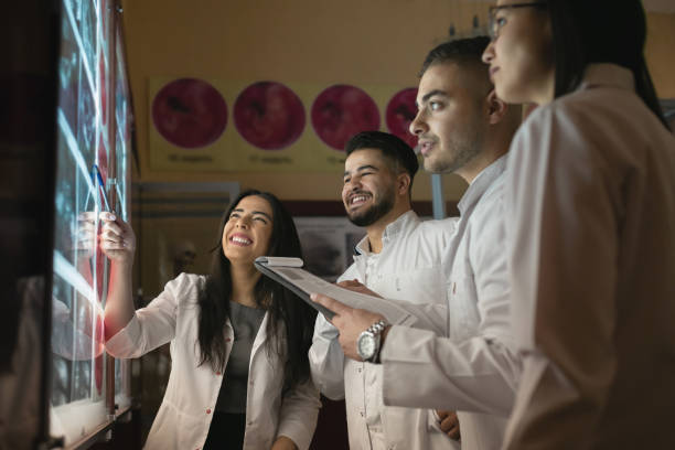 istock A group of surgeon interns is studying fetal development at different stages of pregnancy. Health education concept. Medical students in the classroom with images of ultrasound 1780783582