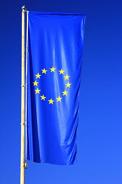 Flag of the European Union Flag of the European Union before blue sky european union symbol stock pictures, royalty-free photos & images