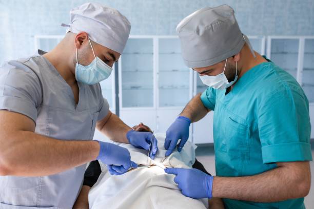Portrait of a multicultural medical team standing in an operating room. Working in hospital office or clinic with other doctors, nurse and surgeon. Portrait of a multicultural medical team standing in an operating room. Working in hospital office or clinic with other doctors, nurse and surgeon. circumcision surgery stock pictures, royalty-free photos & images