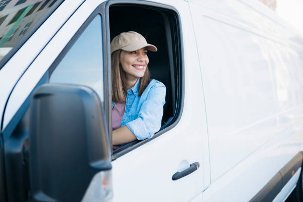 istock Smiling beautiful young woman driving a delivery van 1780790626