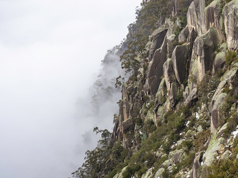 The granite wall of the Gorge at Mount Buffalo in fog Victoria's High Country