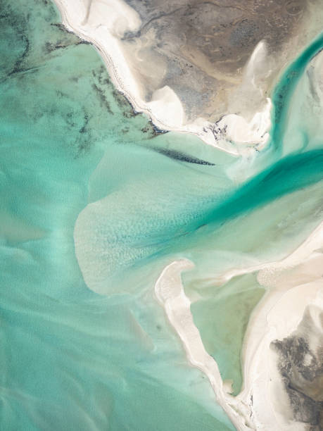 Sand and water ripples from above Abstract aerial view of the remote coast line, Shark Bay Western Australia aircraft point of view stock pictures, royalty-free photos & images