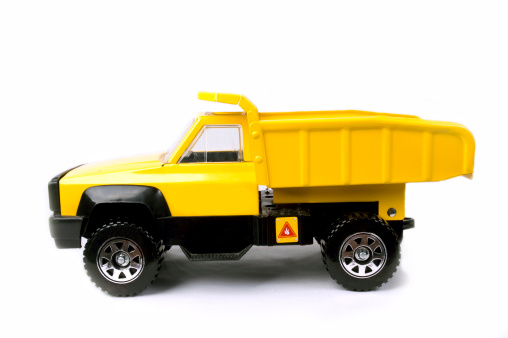 Toy dump truck, side view, shot on white