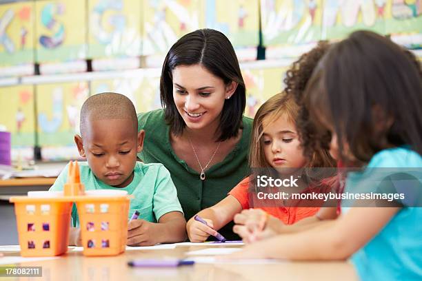 Elementary Art Class Drawing With Teacher At Table Stock Photo - Download Image Now - Teacher, Preschool, Child Care