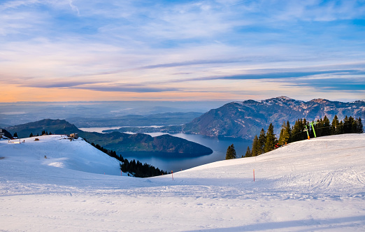 Klewenalp mountain and Lake Lucerne or Vierwaldstattersee at sunset. Mountains covered with snow. Popular ski resort in Swiss Alps and winter sport attraction in Switzerland in winter landscape.