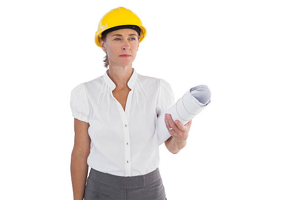 istock Serious female architect holding plans and hard hat 178082378
