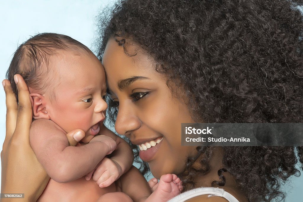 Smiling african mother and baby Smiling African mother holding her 11 days old newborn baby Newborn Stock Photo