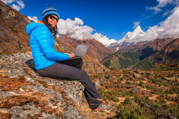 istock Young woman using laptop in Himalayas, Nepal 1780829385