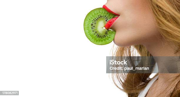 Grils Red Lips Biting A Slice Of Kiwy With Copyspace Stock Photo - Download Image Now