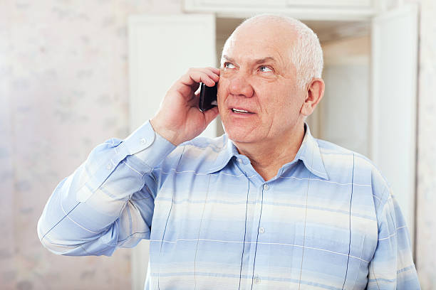 istock mature man speaks by phone 178083132