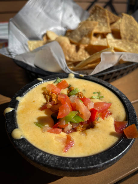 istock Authentic queso dip with some salsa on top served with basket of tortilla chips 1780833709