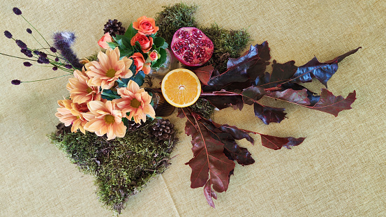 Centro floral con frutos partidos como granada, limón o naranja para la decoración de una mesa de fiesta photo