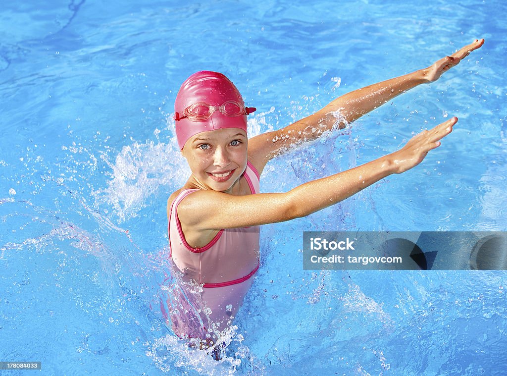 Child swimming in pool. Little girl  swimming in pool. Swimming Pool Stock Photo