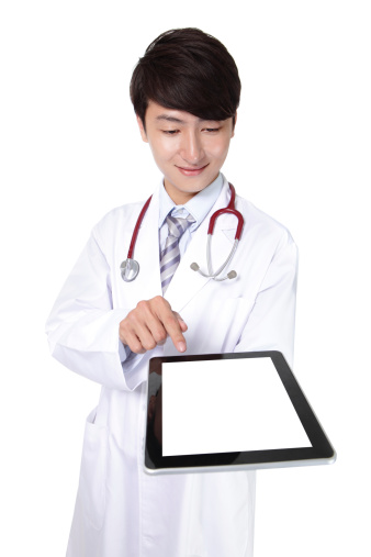 Doctor in white coat with stethoscope showing blank digital tablet pc. Isolated on white background, asian model