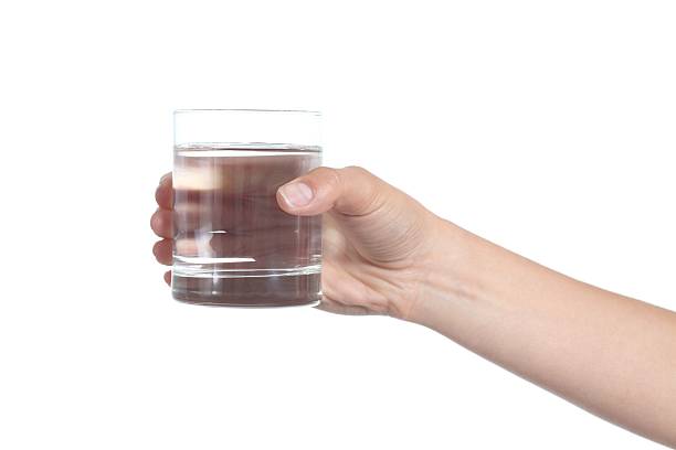 istock Woman hand holding a glass with water 178084341