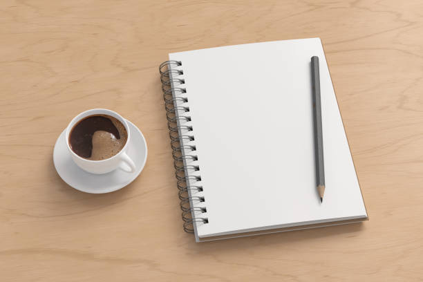 Notebook mockup. Blank notebook, coffee and pencil. Spiral notepad on wooden desk