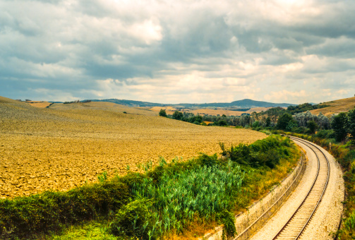 Crete senesi, characteristic landscape in Val d'Orcia (Siena, Tuscany, Italy) at summer. Railway